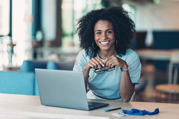 Portrait of a smiling businesswoman with a laptop in the office